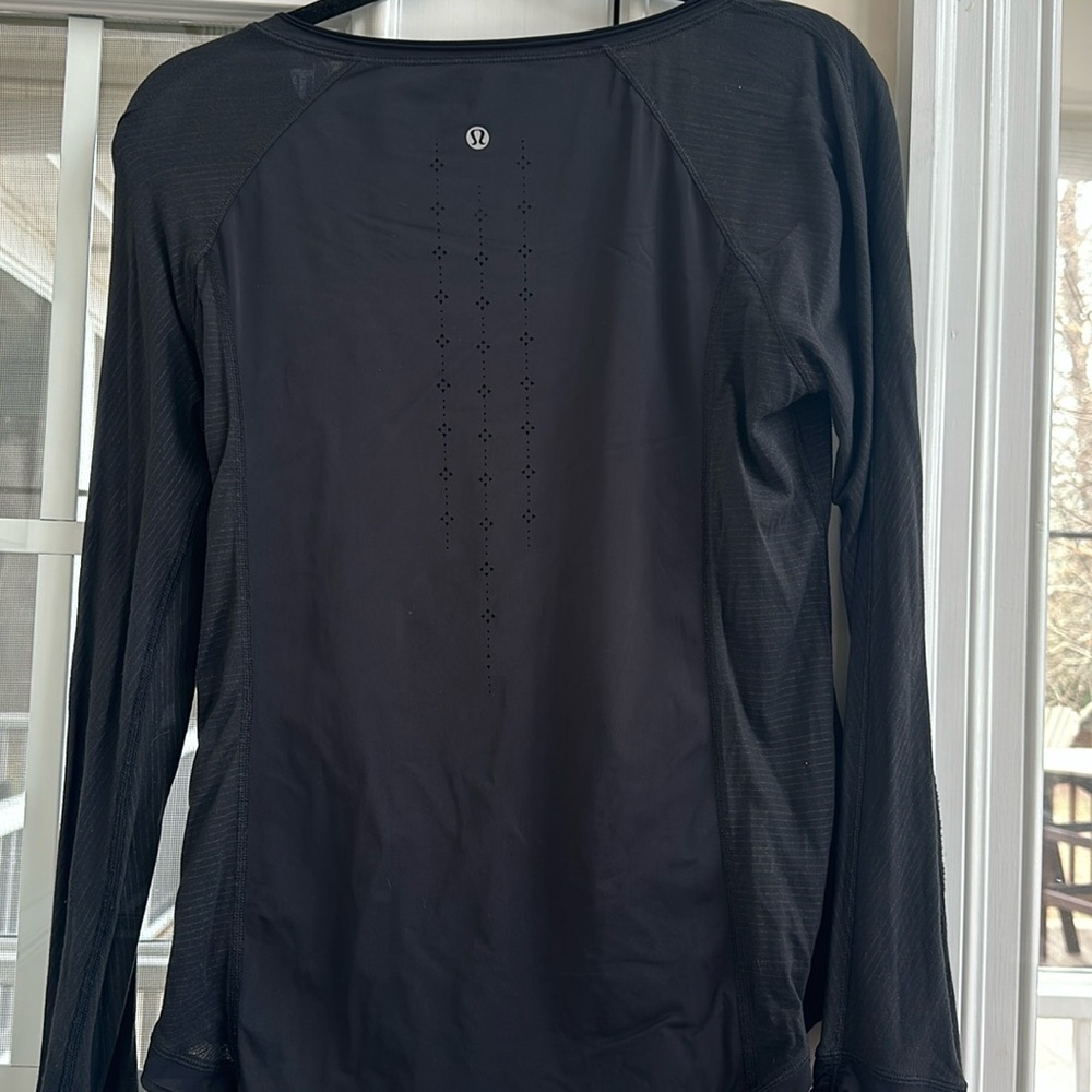 Lululemon black is long sleeve lightweight top. Black cut outs.